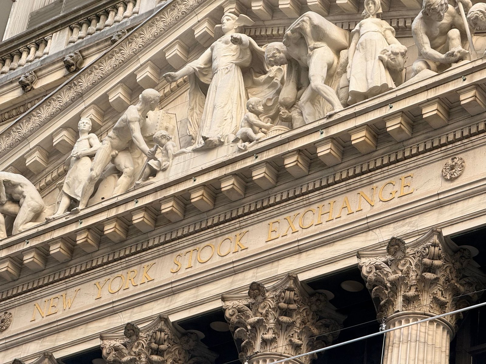 Ornate façade of the New York Stock Exchange featuring intricate stone sculptures during daylight. — Best Forex Trading Tools