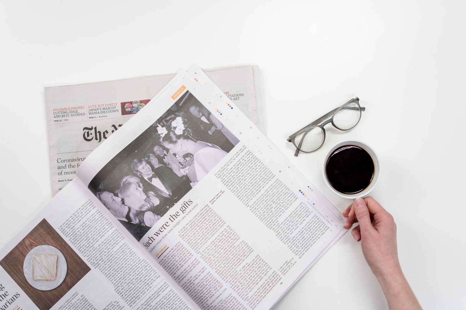 Overhead view of newspaper reading with coffee and glasses on a white table. — How do genetics influence medical weight loss